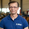 Lächelnde Mann mit kurzen Haaren und Brille